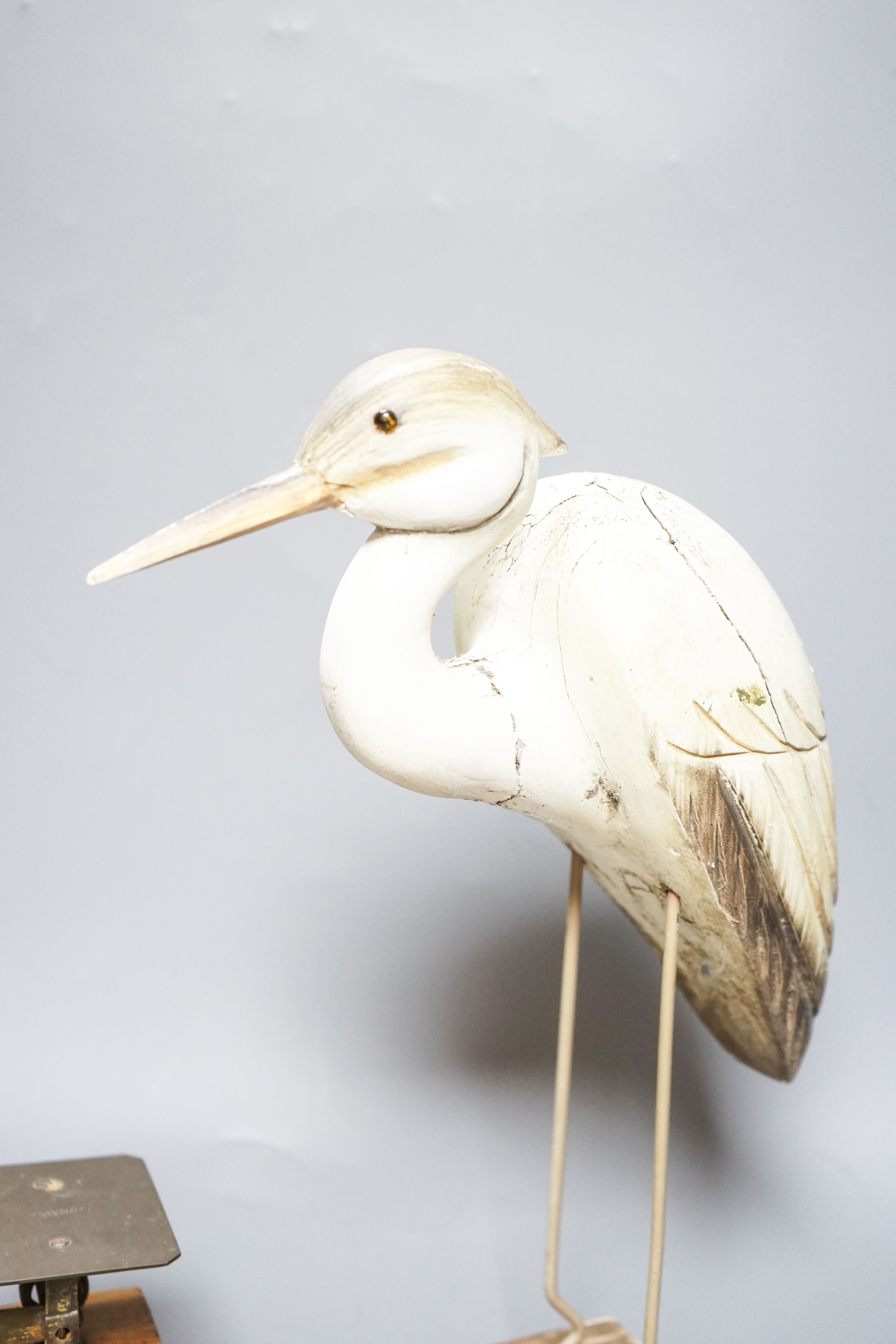 A Ratcliff weighing scale, a painted wrought iron floral wall light, a model of a stork, 33cm